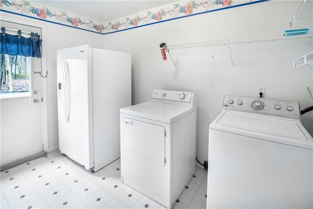 laundry area with laundry area, washer and clothes dryer, and light floors