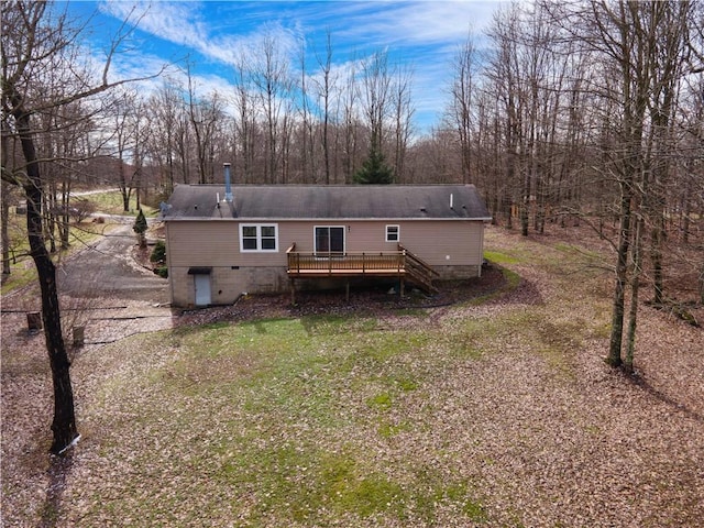 back of house with a wooden deck