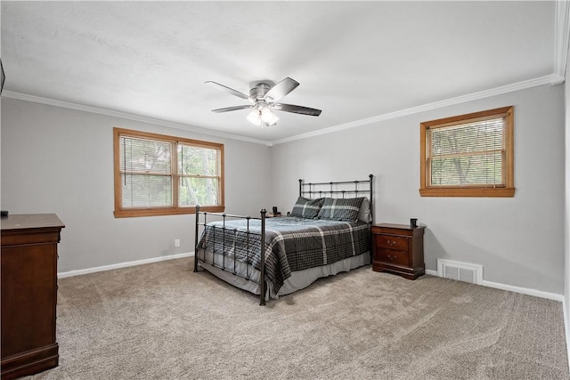 carpeted bedroom featuring baseboards, visible vents, and crown molding