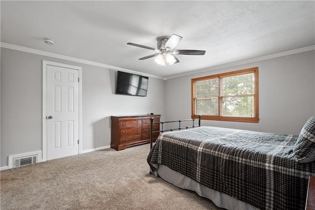 carpeted bedroom with a ceiling fan, baseboards, visible vents, and crown molding