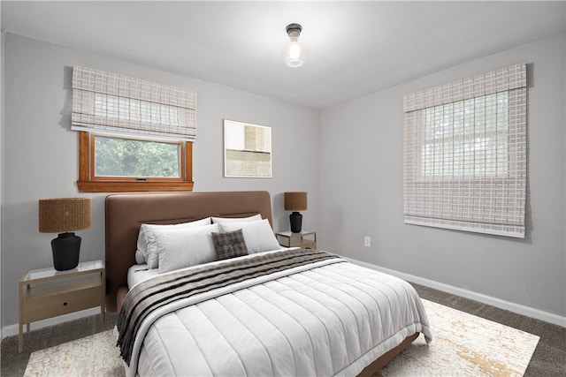 bedroom featuring carpet and baseboards