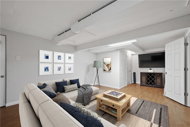 living area featuring baseboards and wood finished floors