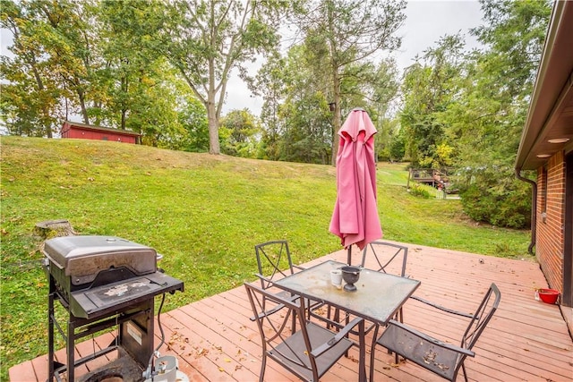 deck with a grill and a yard