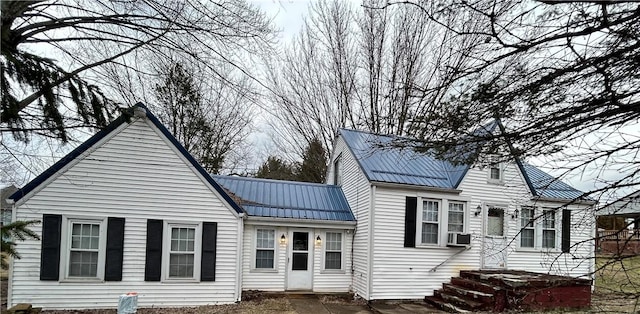 view of front of property with metal roof and cooling unit