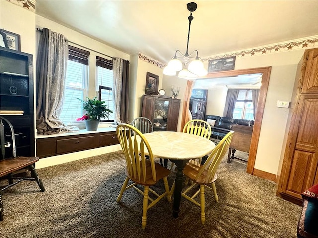 carpeted dining area with baseboards