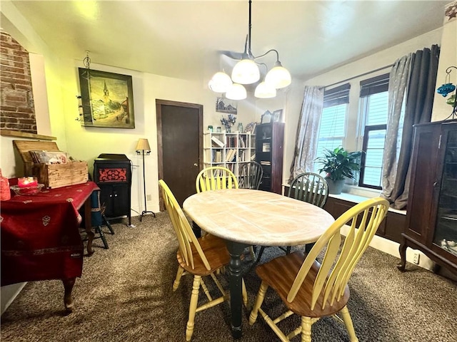 carpeted dining room featuring an inviting chandelier