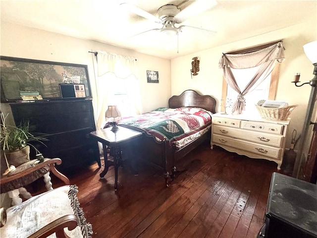 bedroom with ceiling fan and dark wood-type flooring