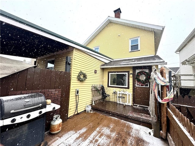 rear view of property with fence