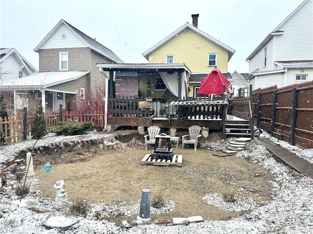 back of property featuring a deck and a fenced backyard