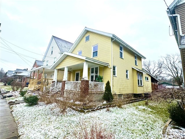 view of side of home featuring a porch