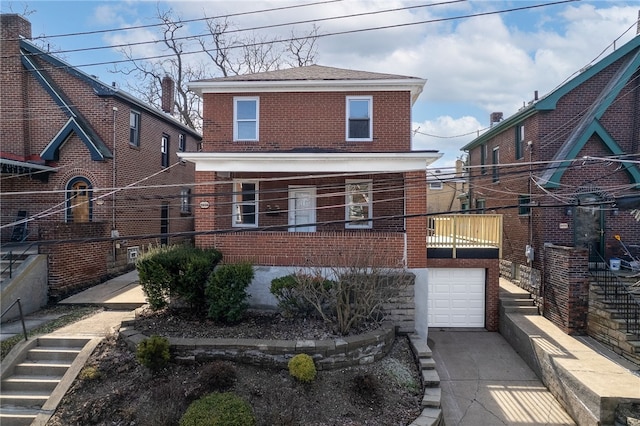 view of front of home with brick siding, driveway, and an attached garage