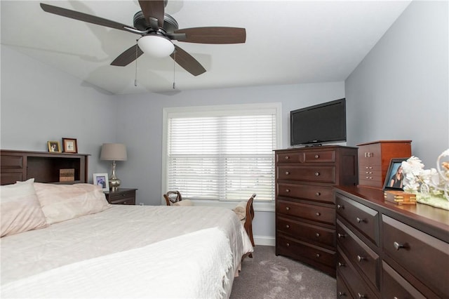 bedroom featuring baseboards, dark colored carpet, and a ceiling fan