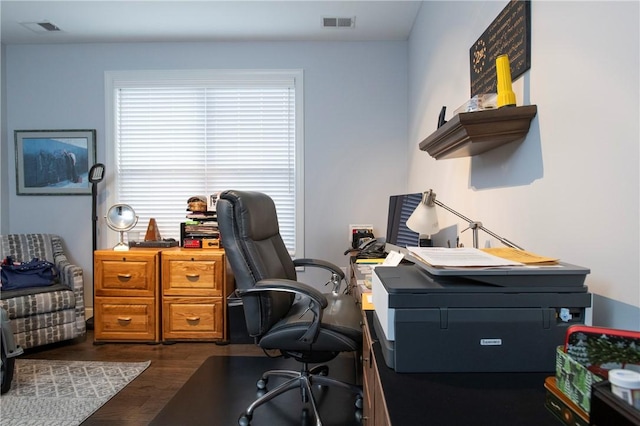 home office with dark wood-type flooring and visible vents