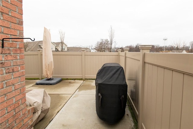 view of patio featuring grilling area and fence