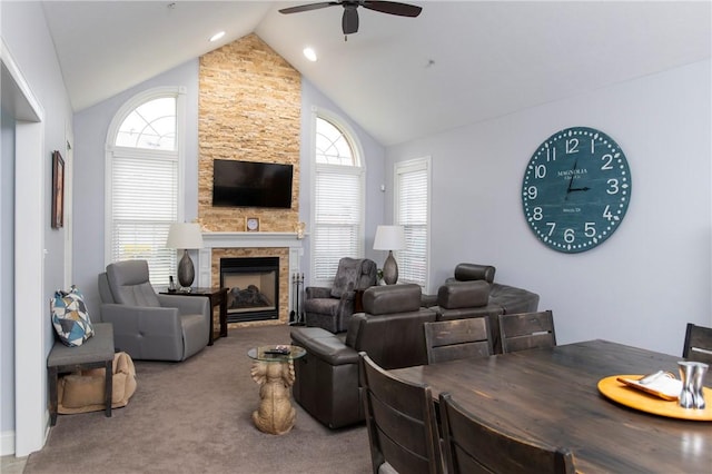 living area featuring a fireplace, plenty of natural light, carpet flooring, and a ceiling fan