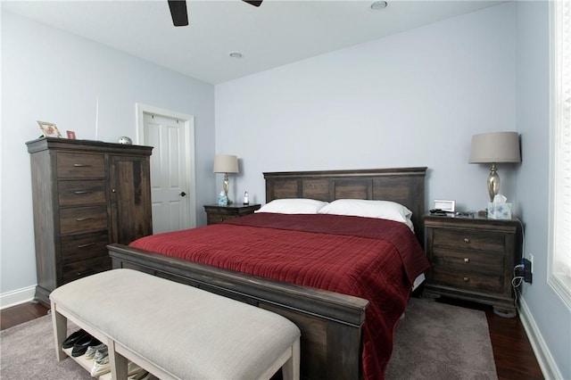 bedroom with ceiling fan, baseboards, and wood finished floors