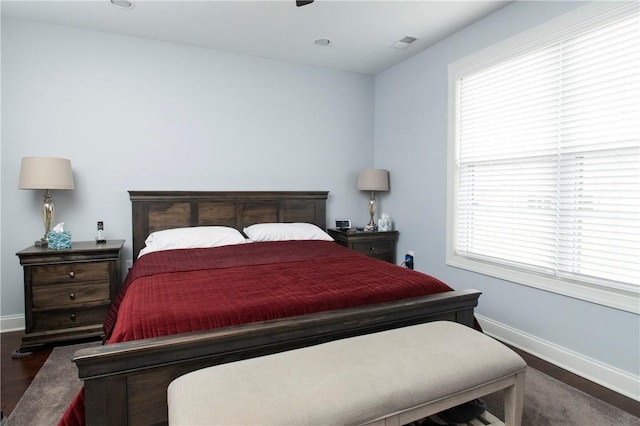 bedroom with baseboards and wood finished floors