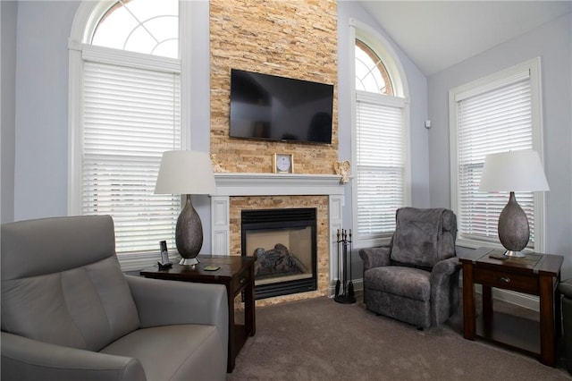 sitting room with carpet floors, a fireplace, and vaulted ceiling