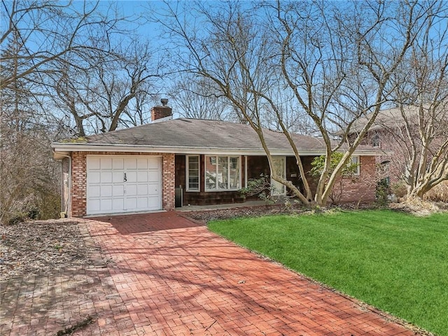 ranch-style home with an attached garage, brick siding, decorative driveway, a chimney, and a front yard