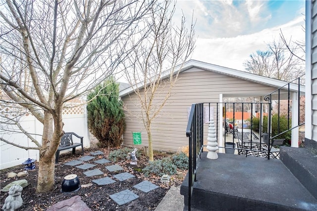 view of property exterior featuring fence