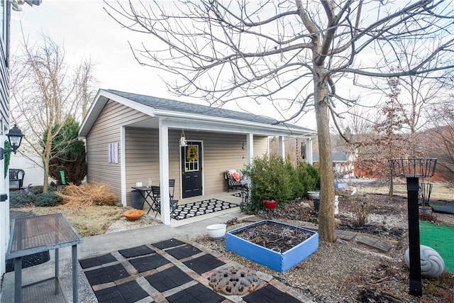 exterior space with a garden and a porch