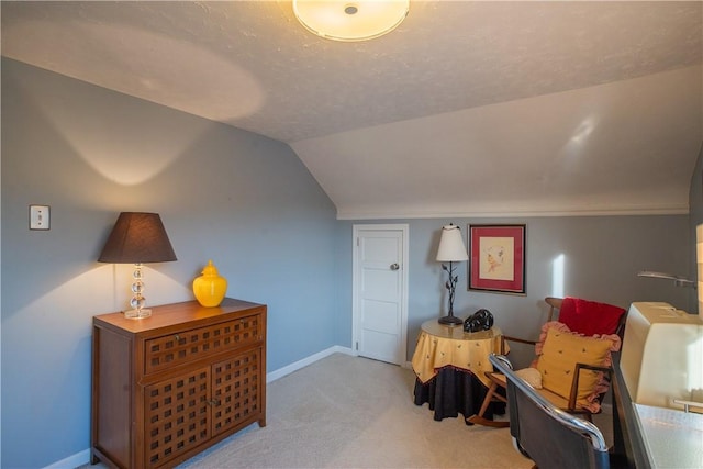 living area featuring lofted ceiling, a textured ceiling, baseboards, and carpet flooring