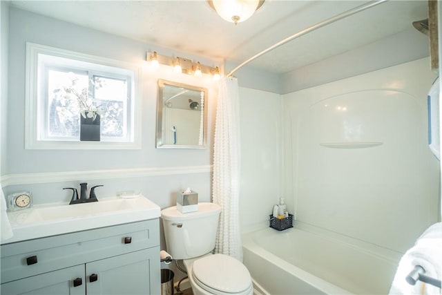 bathroom featuring toilet, shower / bath combination with curtain, and vanity