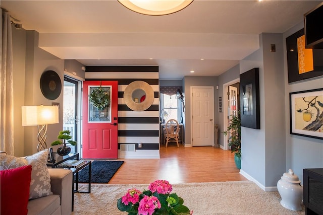 foyer entrance with baseboards and wood finished floors