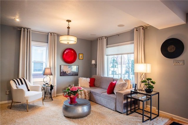 living area featuring carpet floors and baseboards