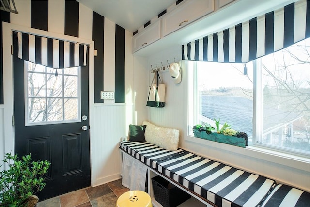 mudroom featuring a wainscoted wall and wallpapered walls