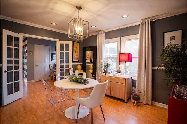 dining space with french doors, recessed lighting, light wood-style floors, ornamental molding, and baseboards