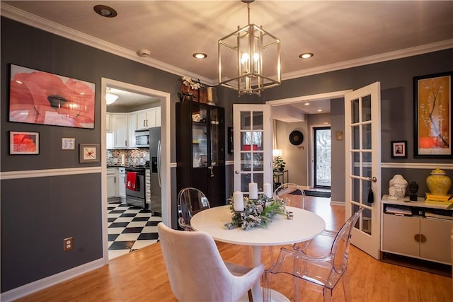 dining area with light wood-type flooring, a chandelier, crown molding, and recessed lighting