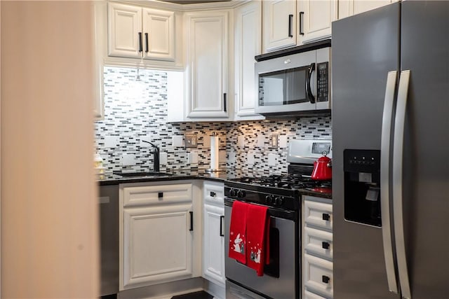 kitchen with a sink, appliances with stainless steel finishes, backsplash, and white cabinets