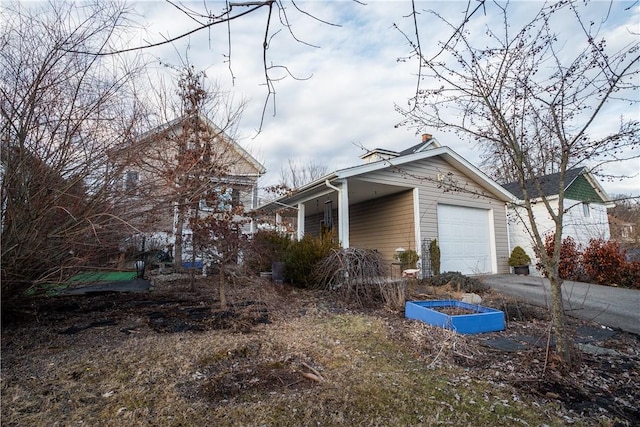 view of property exterior with a garage and aphalt driveway