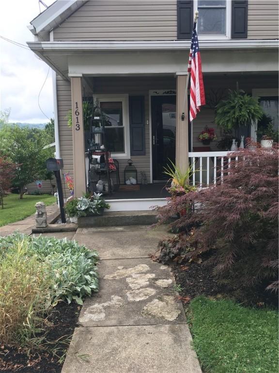 view of exterior entry with covered porch