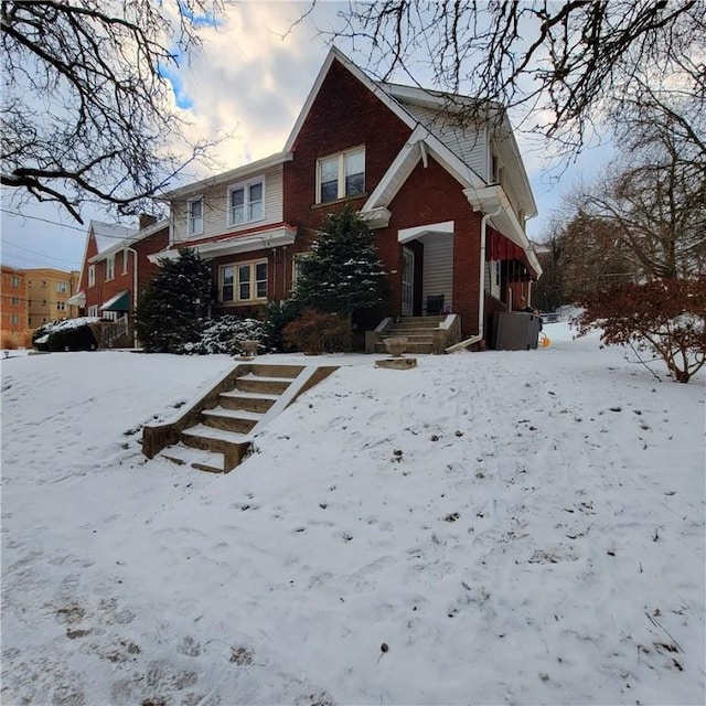 view of front facade featuring a garage and brick siding