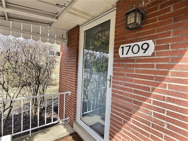 property entrance with brick siding