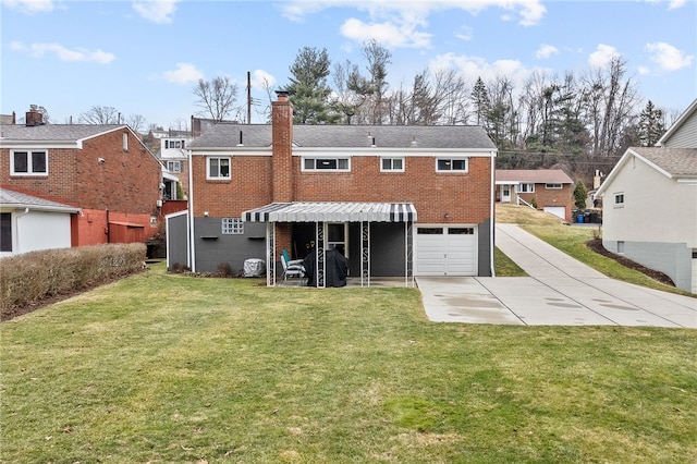 back of property with driveway, a garage, a chimney, and brick siding