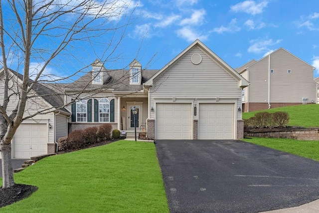 view of front of house with brick siding, driveway, and a front lawn