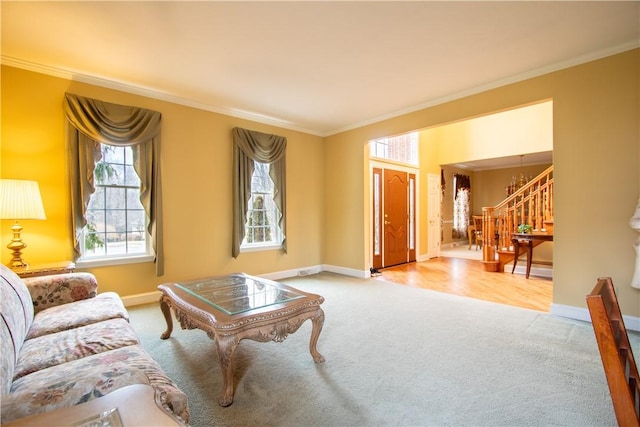 living room featuring carpet, stairway, baseboards, and ornamental molding