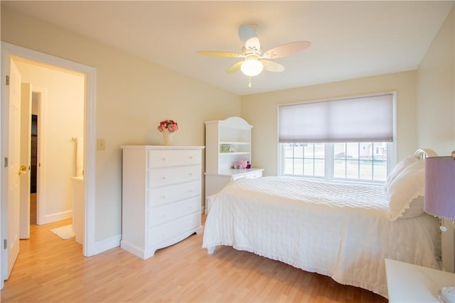 bedroom featuring ceiling fan, light wood-type flooring, and baseboards