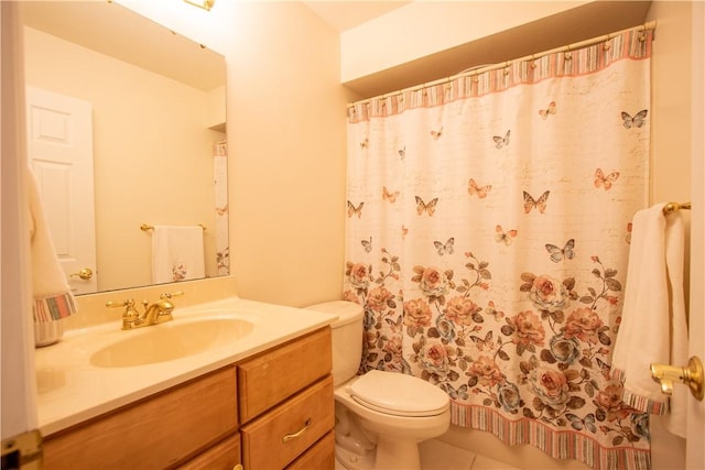 bathroom with curtained shower, vanity, toilet, and tile patterned floors