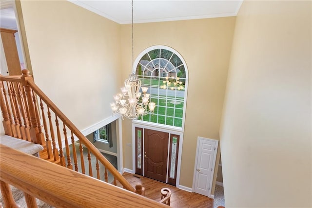 entrance foyer with a towering ceiling, plenty of natural light, and a notable chandelier