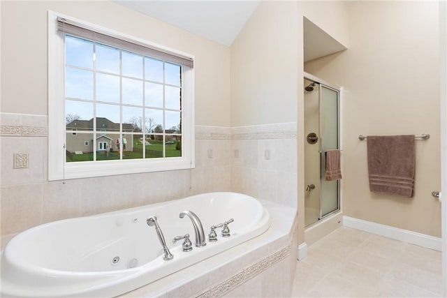 bathroom featuring a tub with jets, a stall shower, tile patterned flooring, and baseboards