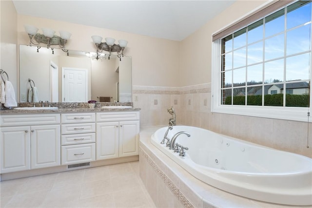 bathroom featuring double vanity, visible vents, a jetted tub, and a sink