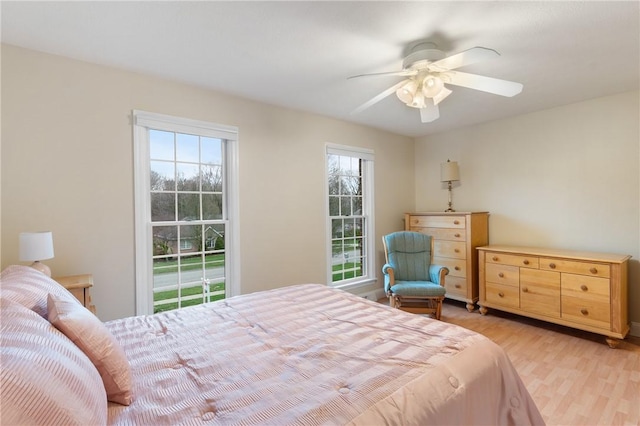 bedroom with a ceiling fan and light wood finished floors