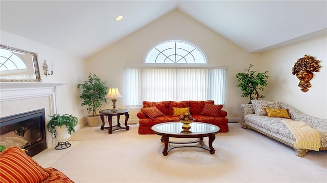 living room with high vaulted ceiling, carpet, a tile fireplace, and baseboards