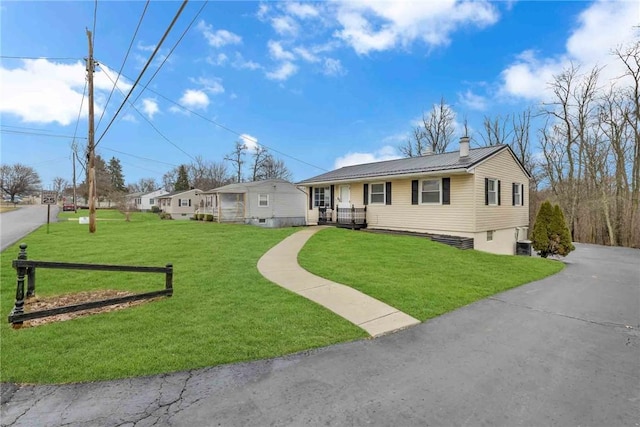 129 Birch St, Brighton Twp, PA 15009 - ranch-style house featuring a front yard, a chimney, metal roof, driveway, and cooling unit