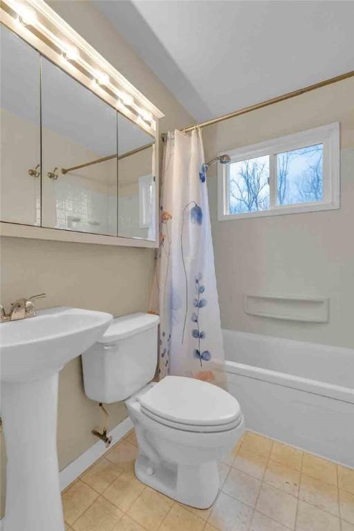 129 Birch St, Brighton Twp, PA 15009 - full bath featuring shower / bath combo with shower curtain, toilet, tile patterned floors, a sink, and baseboards