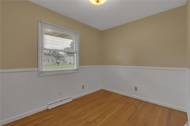 129 Birch St, Brighton Twp, PA 15009 - spare room featuring a baseboard radiator, light wood-style floors, and wainscoting